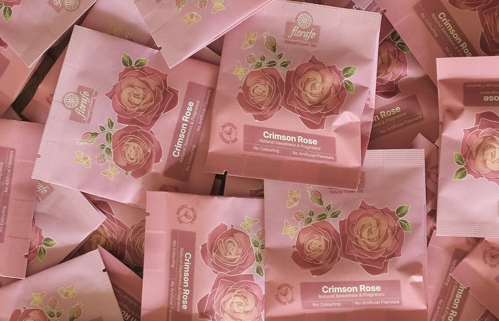 Close up view of a pile of florafo crimson rose whole flower infusion sachets. 